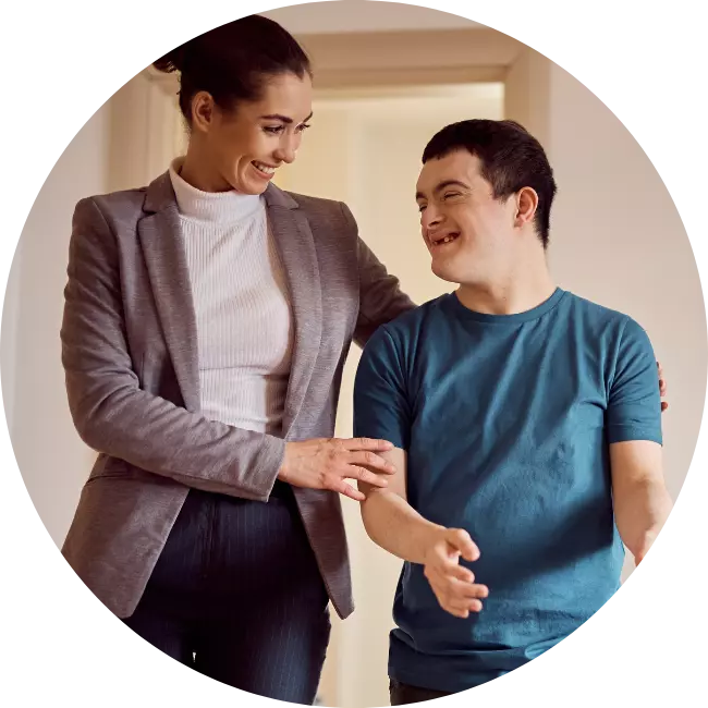 Support worker talking happily to disabled boy